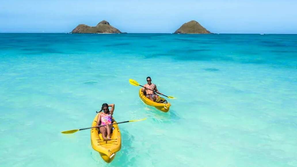 Man and Woman Kayaking with Na Mokulua in the background