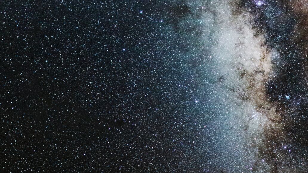 View of Milky Way solar system in night sky over volcanic pu'u hill on the slope of sacred Mauna Kea mountain in Hawaii