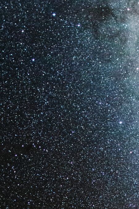 View of Milky Way solar system in night sky over volcanic pu'u hill on the slope of sacred Mauna Kea mountain in Hawaii