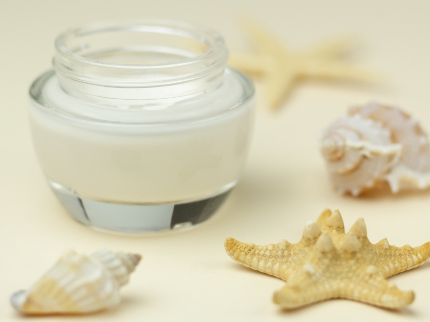 Skincare for summer – closeup of a moisturizer and starfish.