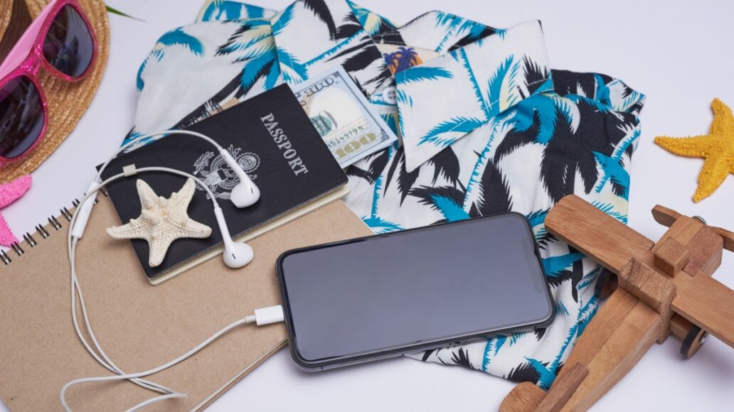 Flat lay travel accessories on white background palm leaf, camera, hat, passports, money, hawaii, book, phone, and sunglasses. Top view, travel or vacation concept. Summer background.