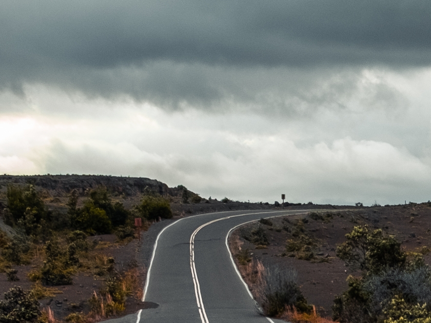 (Crater Rim Drive) in the Hawaii Volcanoes National Park after earthquake and eruption of Kilauea (fume at upper right) volcano in May 2018. Big Island, Hawaii