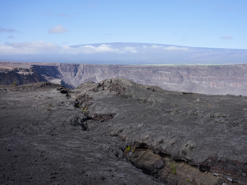 Kīlauea caldera seen from Keanakāko'i Overlook in Hawaii Volcanoes National Park with Mauna Loa in the background on November 27, 2019.