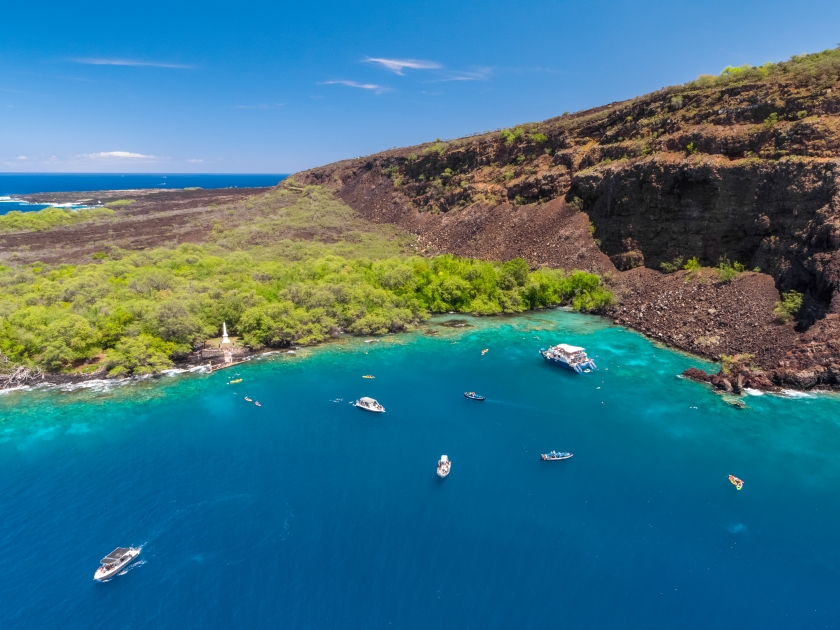 Aerial drone view the Captain James Cook Monument in Kealakekua Bay, Big Island, Hawaii. The monument marks the spot where James Cook was killed in a fight with native Hawaiians in 1779.