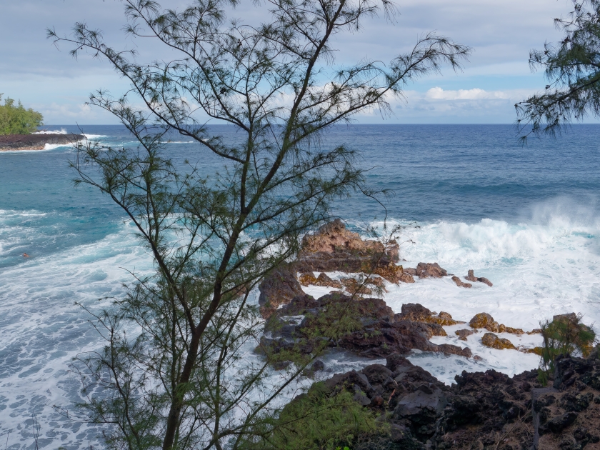 Waves splashing at rocks at Kehena black sand beach located in the Big Island's Puna district, Hawaii