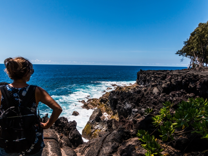 Female Hiker Above The Rugged Volcanic Sea Cliffs of Mackenzie State Recreation Area, Hawaii Island, Hawaii, USA