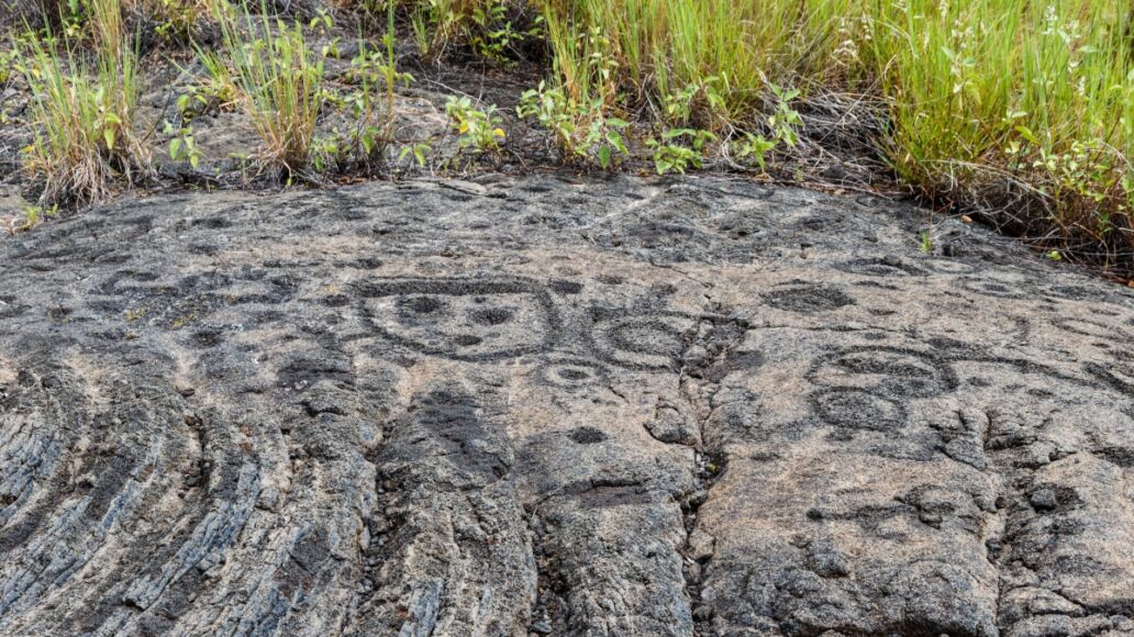 Petroglyphs in lava rock at Pu'uloa along Chain of Craters road, in volcano National Park on the island of Hawaii. Carvings are 400-700 years old.