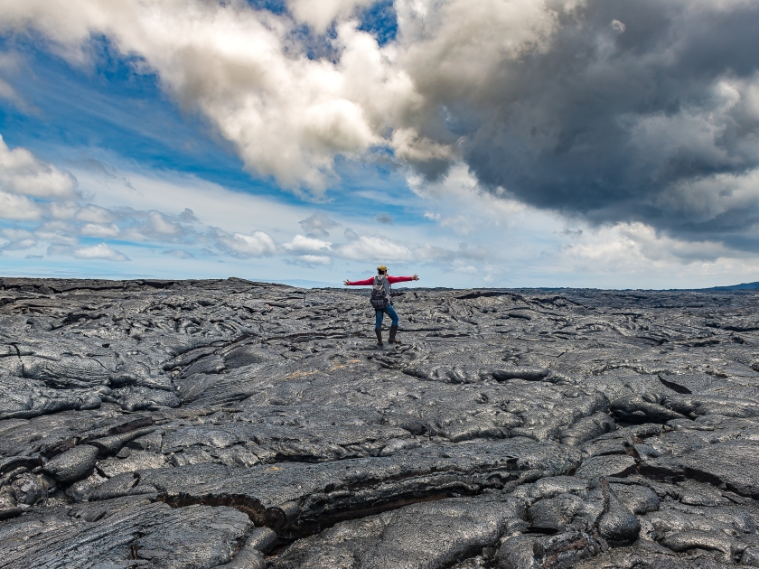 Hiker standing on Active Lava field at Hawaiian Vocalnoes National Park Hawaii