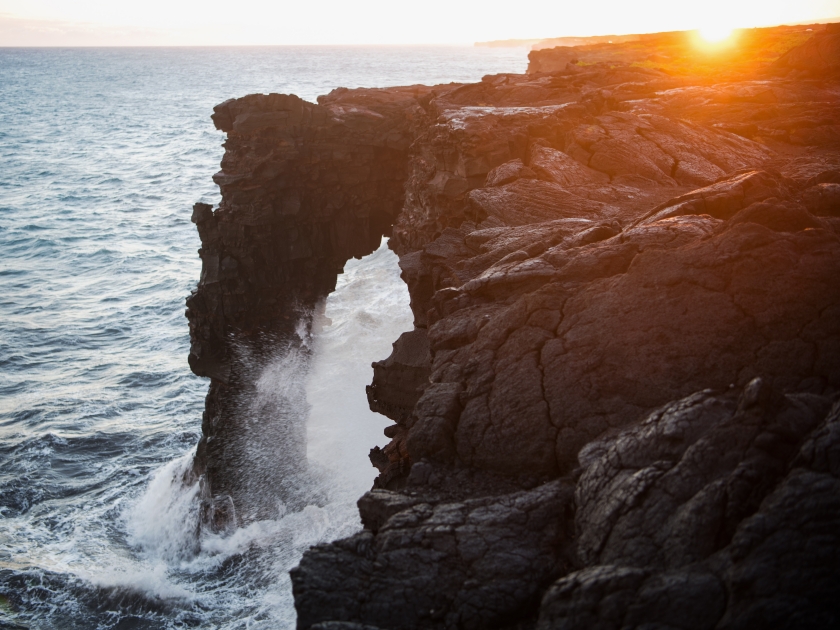 Holei Sea Arch at sunset. The natural arch is located at the end of the Chain of Craters Road and a highlight of the Volcanoes National Park on Hawai'i's Big Island