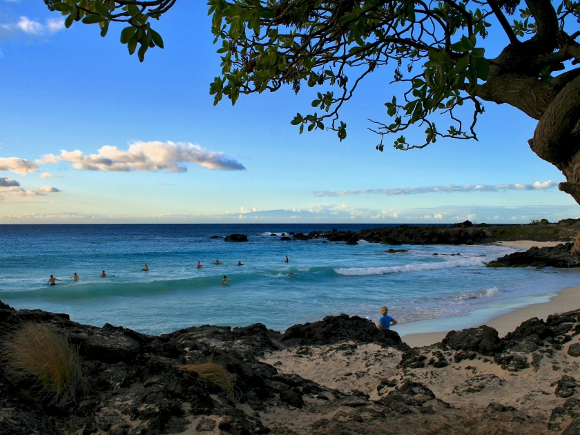 Surfers on Manini'owali beach in Hawaii