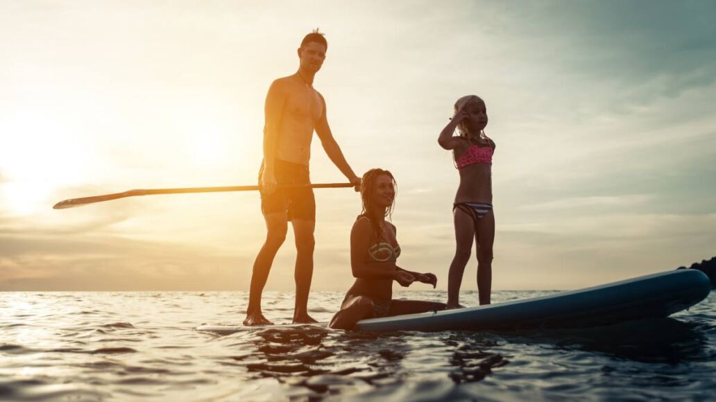 surfing. happy family silhouette on the paddle board. concept about family, sport and fun