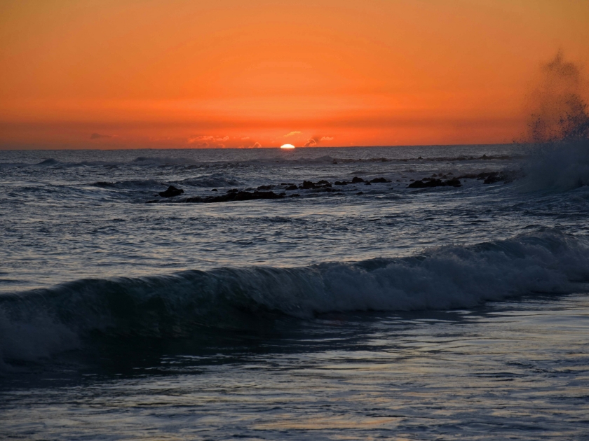 sunset and waves in poipu, kauai, hawaii, as seen from brennecke's beach