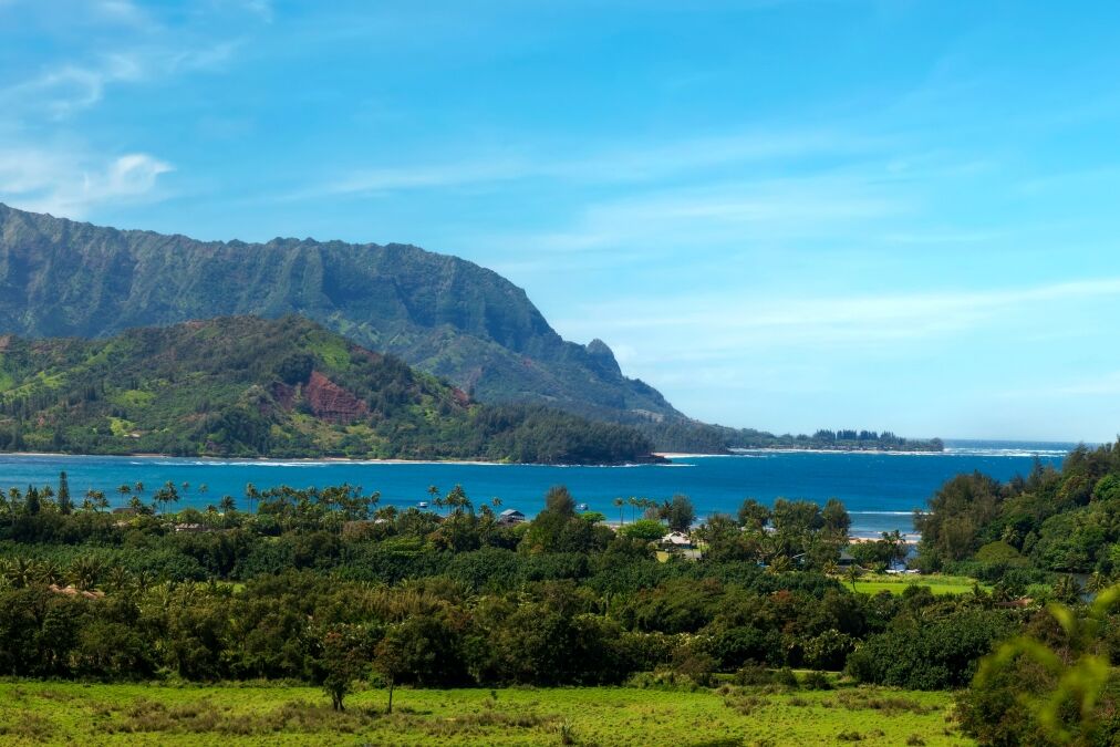 Panoramic view of Hanalei Bay, Kauai, Hawaii. The crescent-shaped Hanalei Bay is one of Hawaii’s most scenic and pleasant beaches, set beneath a range of monumental mountain peaks.