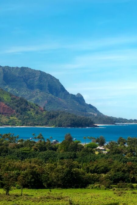 Panoramic view of Hanalei Bay, Kauai, Hawaii. The crescent-shaped Hanalei Bay is one of Hawaii’s most scenic and pleasant beaches, set beneath a range of monumental mountain peaks.