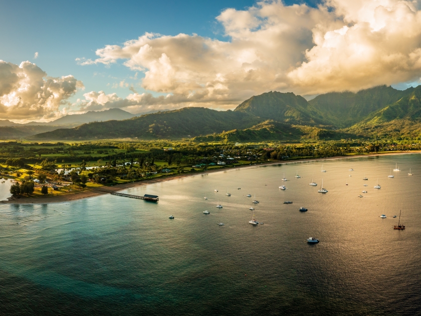 Aerial view of the bay and town of Hanalei with famous pier as the sun rises over the wildlife refuge