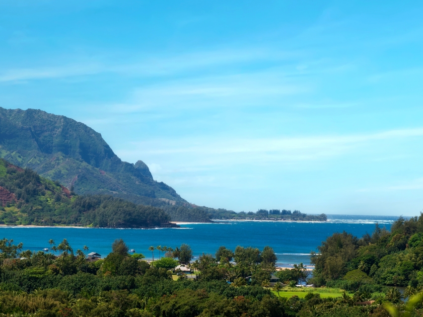 Panoramic view of Hanalei Bay, Kauai, Hawaii. The crescent-shaped Hanalei Bay is one of Hawaii’s most scenic and pleasant beaches, set beneath a range of monumental mountain peaks.