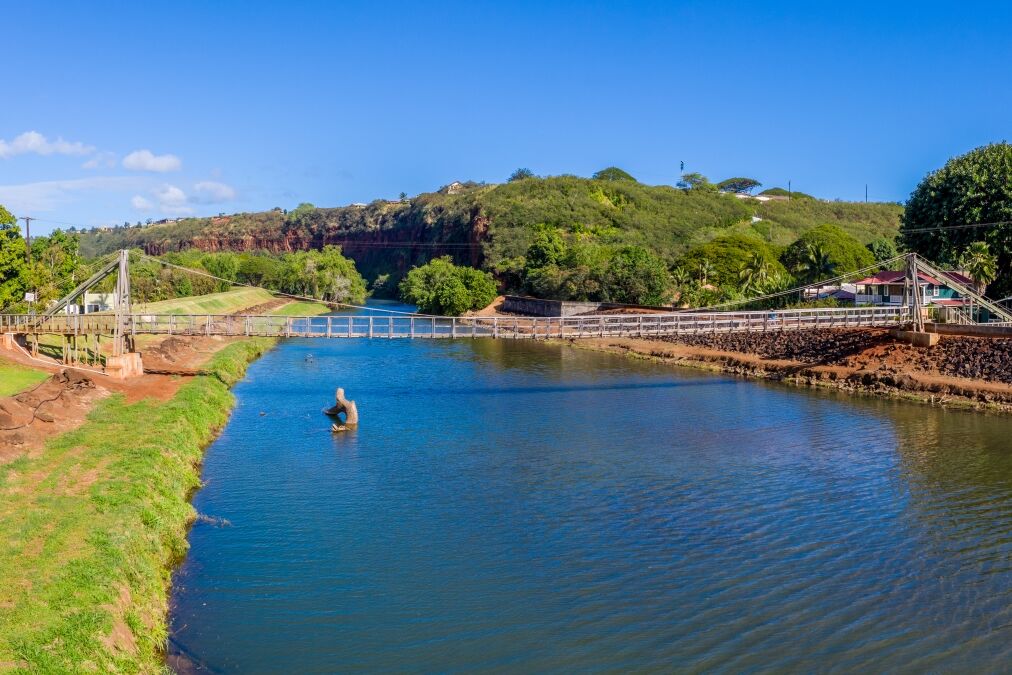 Aerial drone view of the wooden swinging bridge of Hanapepe over the river on Kauai