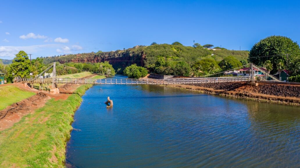 Aerial drone view of the wooden swinging bridge of Hanapepe over the river on Kauai