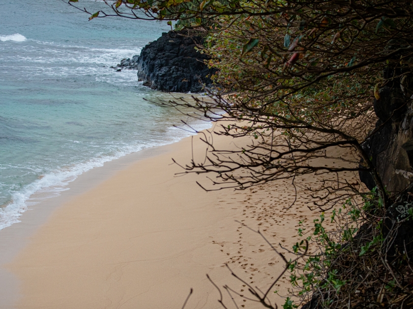 Hideaway Beach in Princeville, north shore of Kauai, Hawaii, a small secluded beach on the north shore of Kauai with a steep trail leading to it