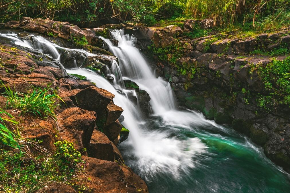 A side view of Hoʻopiʻi Falls, a series of waterfalls along the Kapaʻa Stream, located near Kapaʻa town on the island of Kauai, Hawaii, United States.