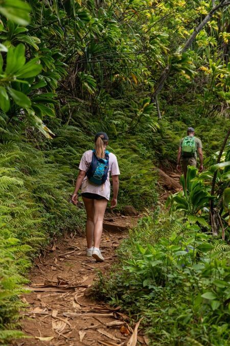 Hikers at beautiful Kalalau Trail at Na Pali Coast on the island of Kauai, Hawaii