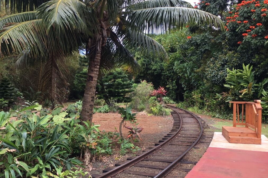 Railway tracks go through a tropical garden at the Kauai Plantation Railway on Kauai, Hawaii.