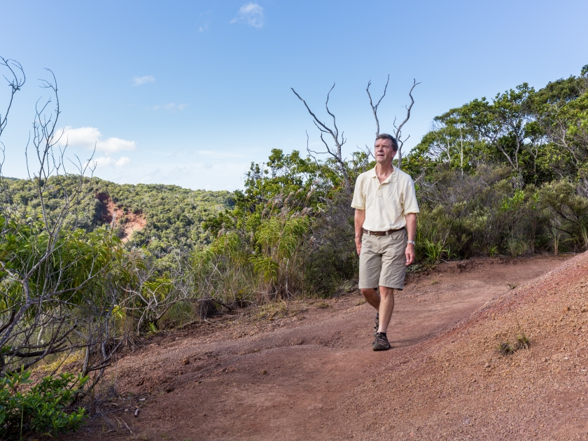 Senior male hiker on Awa`awapuhi trail from Koke'e State Park to Na Pali coast in Kauai, Hawaii, USA