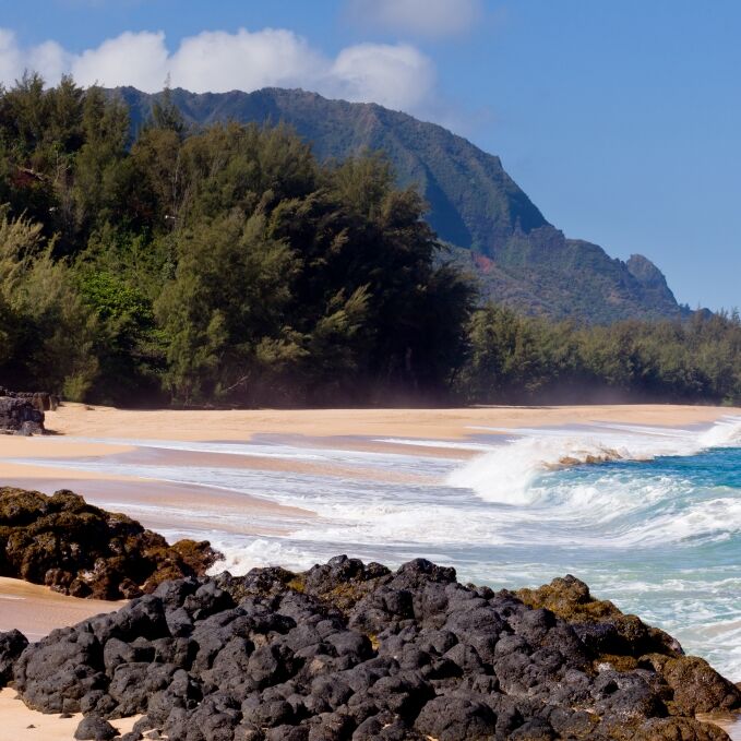 Waves crash onto Lumahai beach on Kauai Hawaii with Na Pali Coast