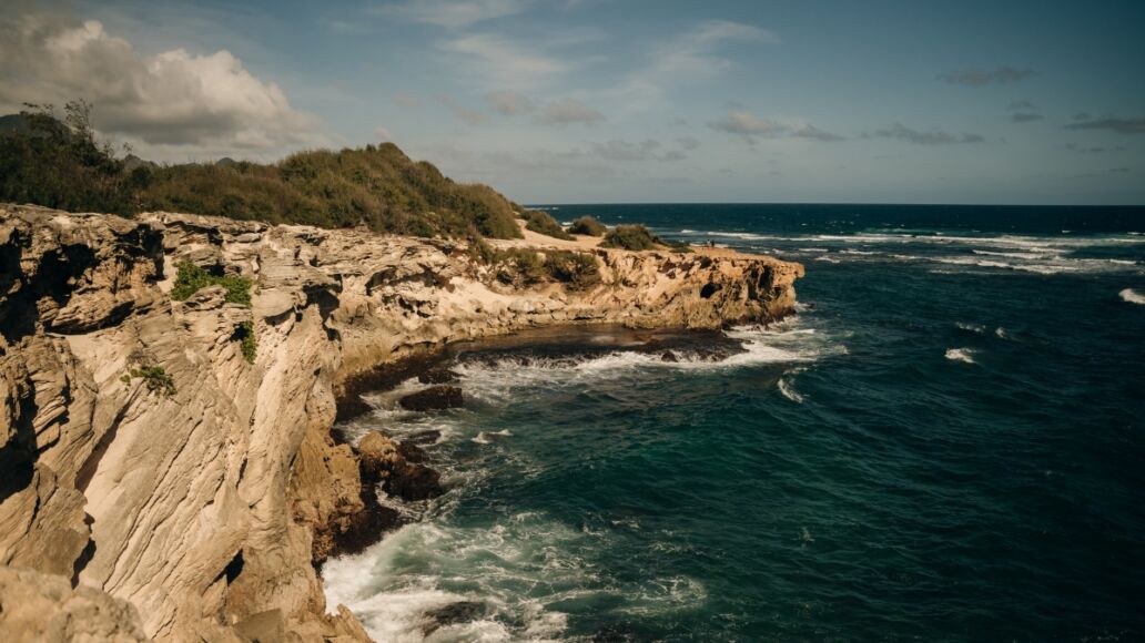 A view of the Pacific Ocean from the cliffs of the Mahaulepu Heritage Trail in Poipu, Kauai, Hawaii, USA. High quality photo