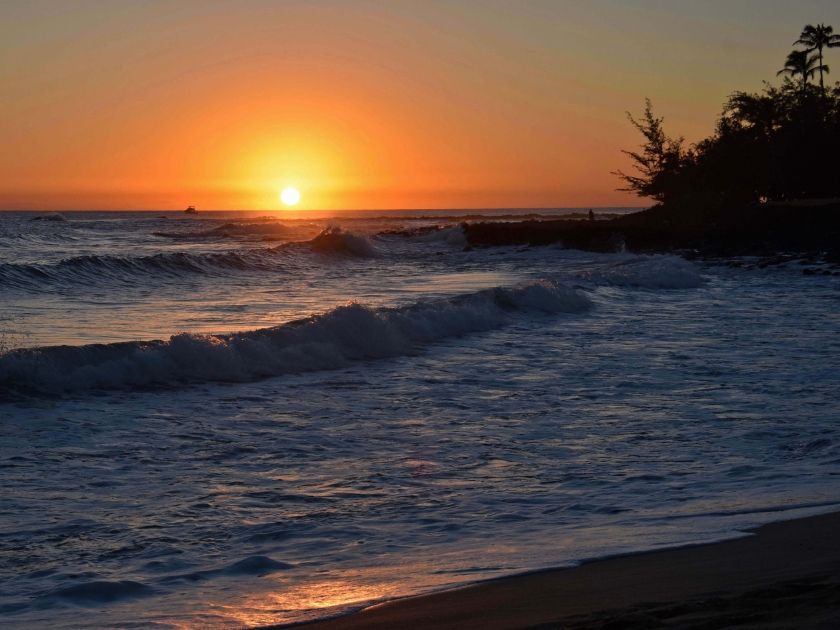 sunset and crashing waves in poipu, kauai, hawaii, as seen from brennecke's beach