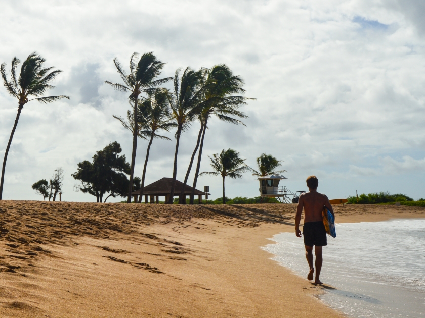 Hawaiian surfer walk, Salt Pond Beach, Kauai, Hawaii