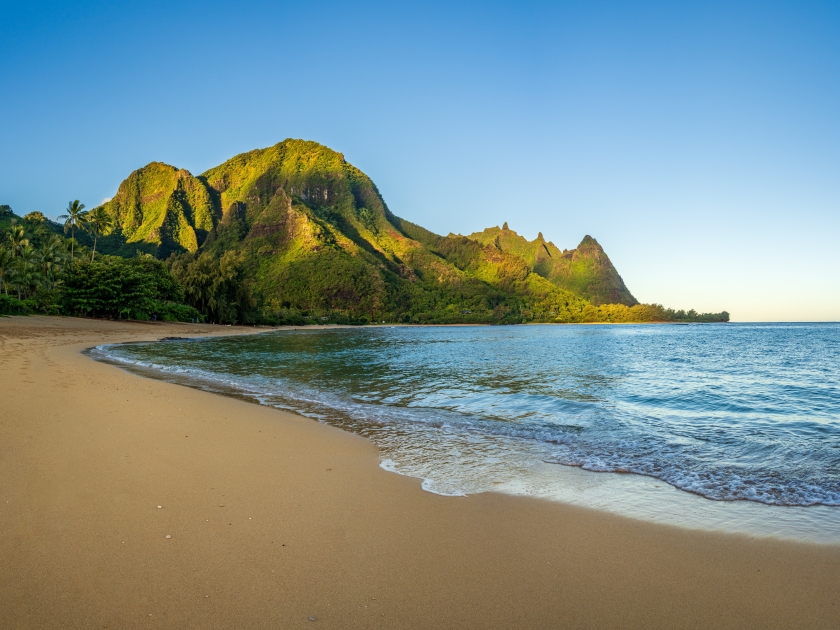 Aerial panoramic image of early morning light just catching the mountains. Tunnels beach on Hawaiian island of Kauai