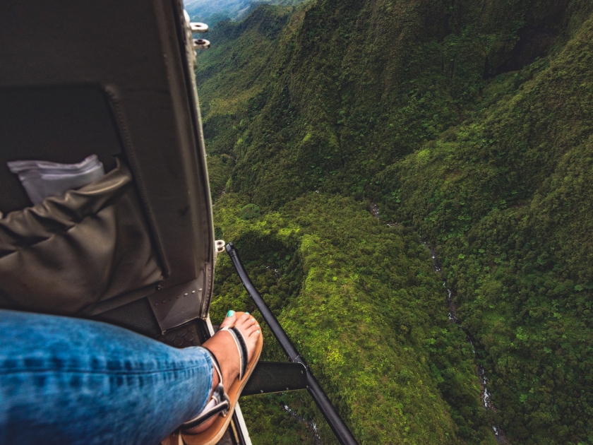 Looking out of a doors-off helicopter tour over the Wai'ale'ale Blue Hole Crater in the center of the island of Kauai, Hawaii, United States.