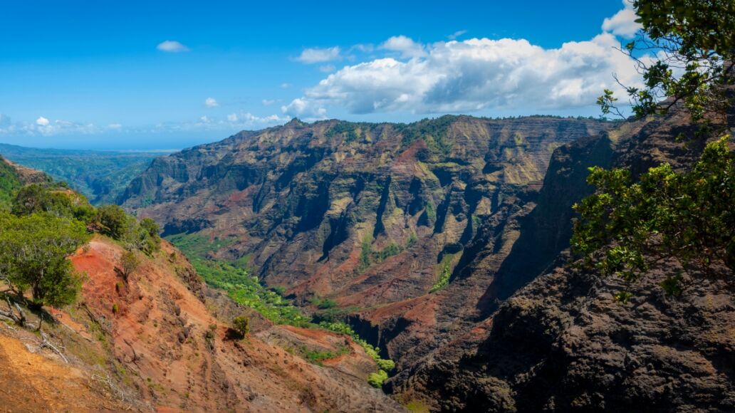 Waimea Canyon, Kauai, Hawaii. Waimea Canyon, on Kauai's West Side, is described as “The Grand Canyon of the Pacific.” The canyon is 14 miles long, 1 mile wide and more than 3,600 feet deep.