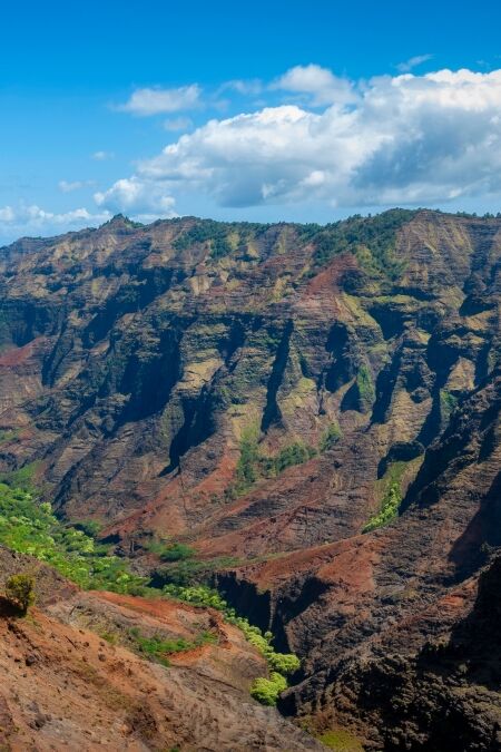 Waimea Canyon, Kauai, Hawaii. Waimea Canyon, on Kauai's West Side, is described as “The Grand Canyon of the Pacific.” The canyon is 14 miles long, 1 mile wide and more than 3,600 feet deep.