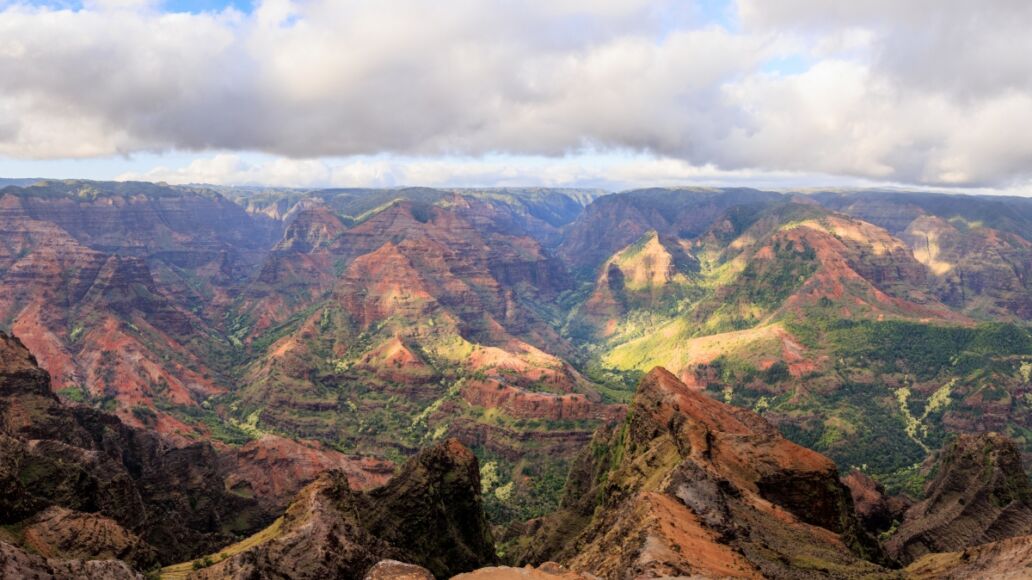 Waimea Canyon shows great contrast of red and greens making a gorgeous mosaic of color in Kauai, Hawaii