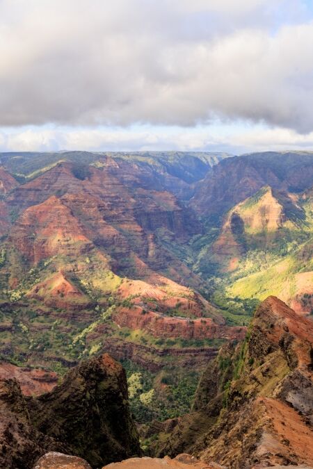 Waimea Canyon shows great contrast of red and greens making a gorgeous mosaic of color in Kauai, Hawaii