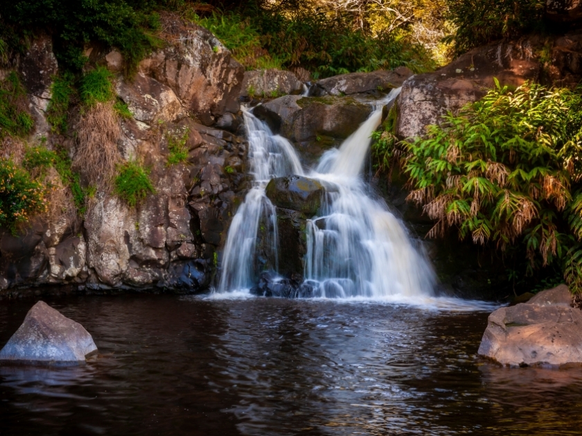 Waipoo Falls, Waimea Canyon, Kauai, Hawaii. A lovely little waterfall located on the Waipoo Falls Trail deep in the canyon and is a great spot to picnic and cool off in the shallow pool.