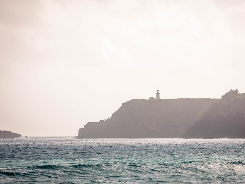 View of Kilauea Lighthouse located in Kilauea Point National Wildlife Refuge, in a photo taken from Kauapea (Secret) Beach, a secluded beach with a high cliff, Kauai, Hawaii