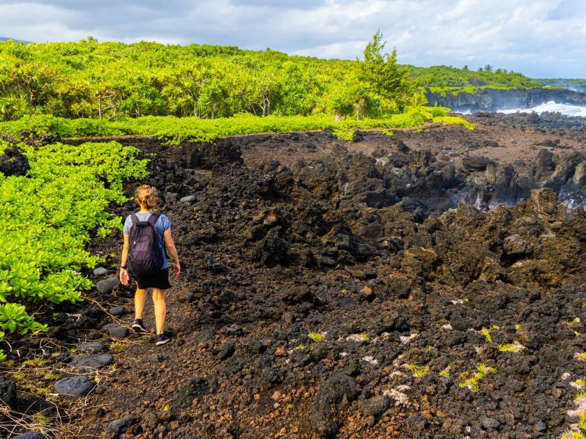 Female Hiker on The Kings Trail Along The Rugged Lava Coastline Near Kauiau Point, Waianapanapa State Park, Maui, Hawaii, USA