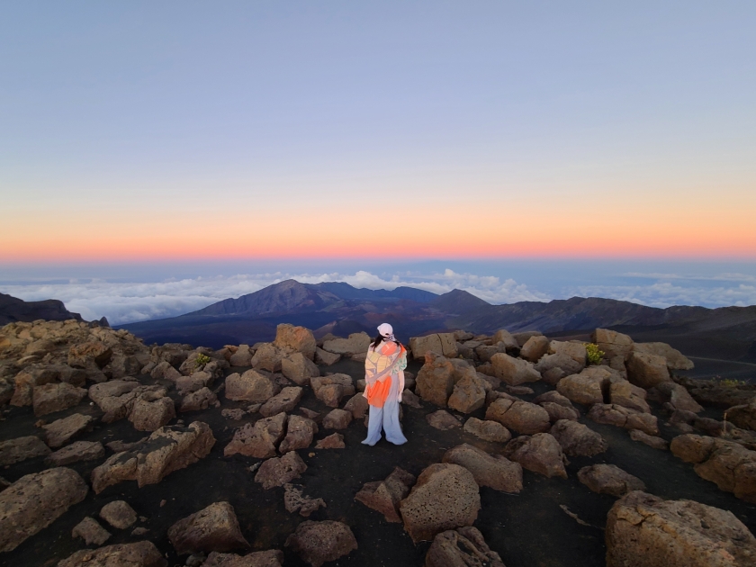 Person watching the sunset on top of Haleakala Volcano in Maui, Hawaii