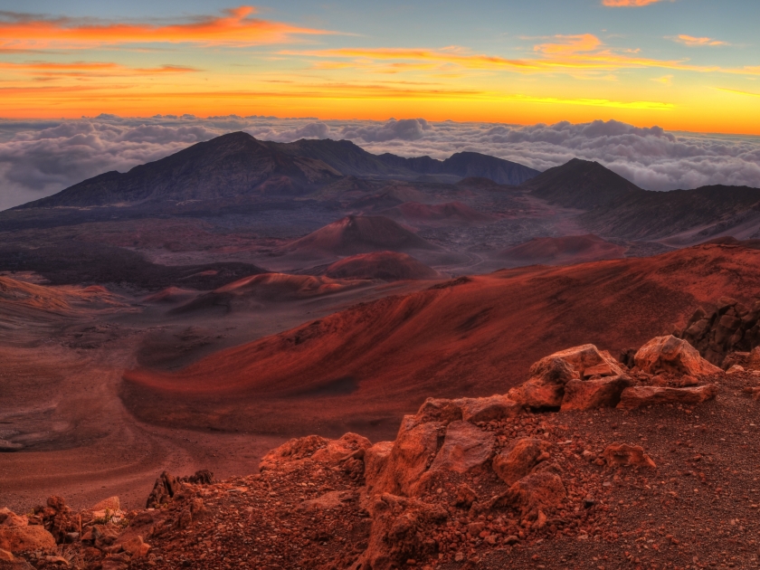 Volcanic crater landscape with beautiful orange clouds at sunrise taken at Haleakala National Park in Maui, Hawaii.