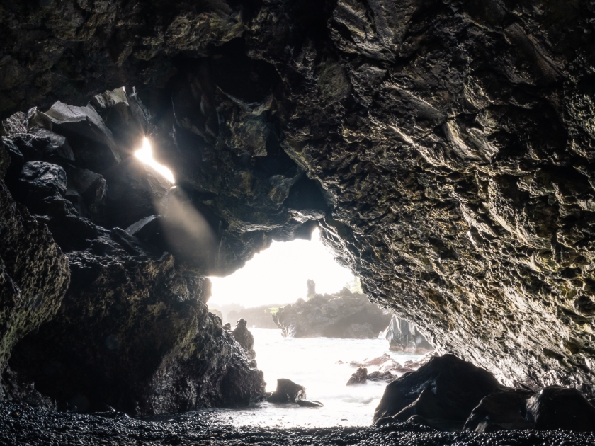 Lava tube leading to the ocean on the famous Black Sand Beach in Waianapanapa State Park in Maui, Hawaii.