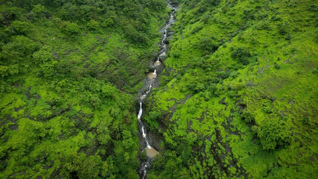 A drone shot of a Honokohau waterfall, Hawaii