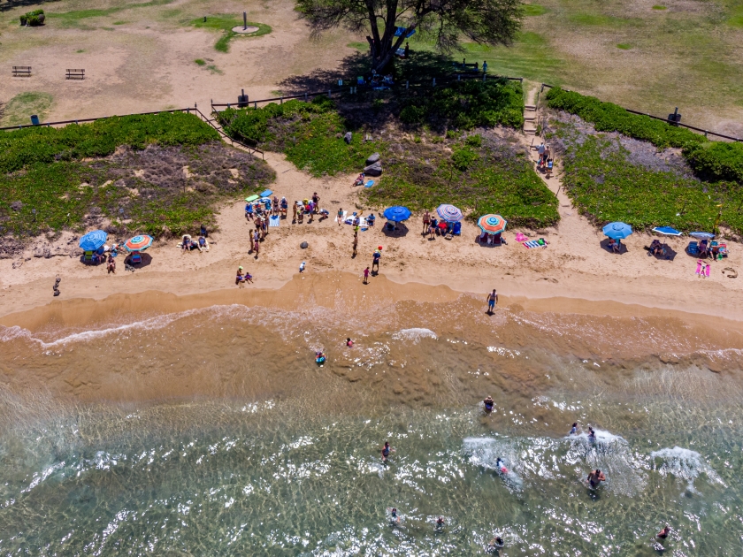 Aerial view a a part of Kamaole III beach, Kihei, Hawaii. People on the beach enjoy sunny weather and warm ocean