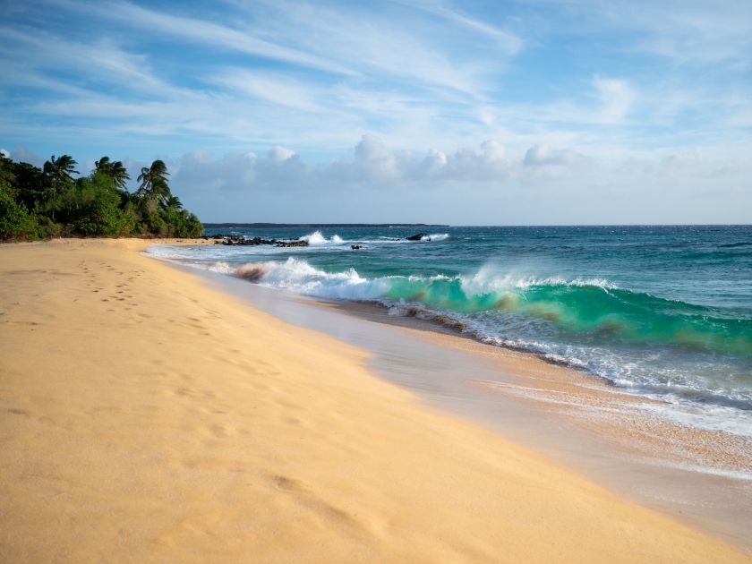 A sunset walk on Makena Beach, Maui, Hawaii. A foot print path along the shoreline by Big Beach.