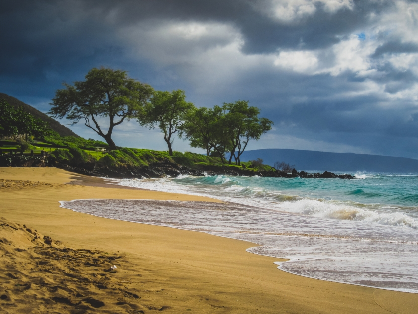 Calm waves on an empty Maluaka Beach on a cloudy day, Maui, Hawaii