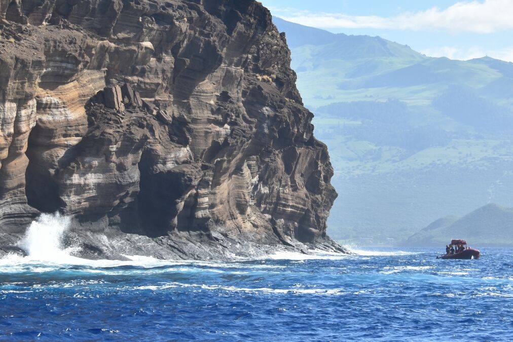 A beautiful shot of the Molokini crater washed by the Pacific ocean waves on a sunny day in Hawaii