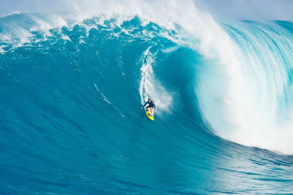 MAUI, HI - MARCH 13: Professional surfer Carlos Burle rides a giant wave at the legendary big wave surf break known as 