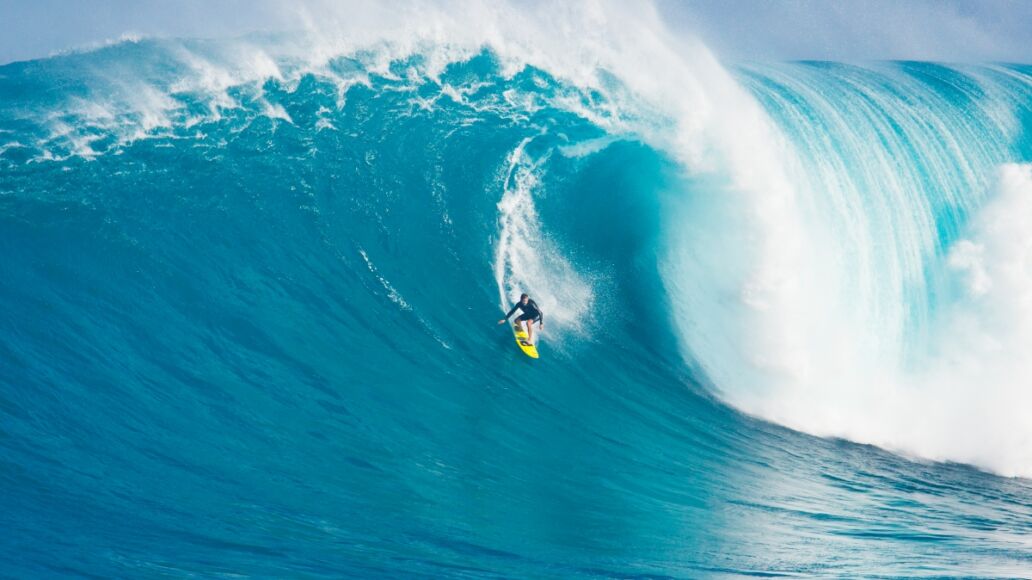 MAUI, HI - MARCH 13: Professional surfer Carlos Burle rides a giant wave at the legendary big wave surf break known as 